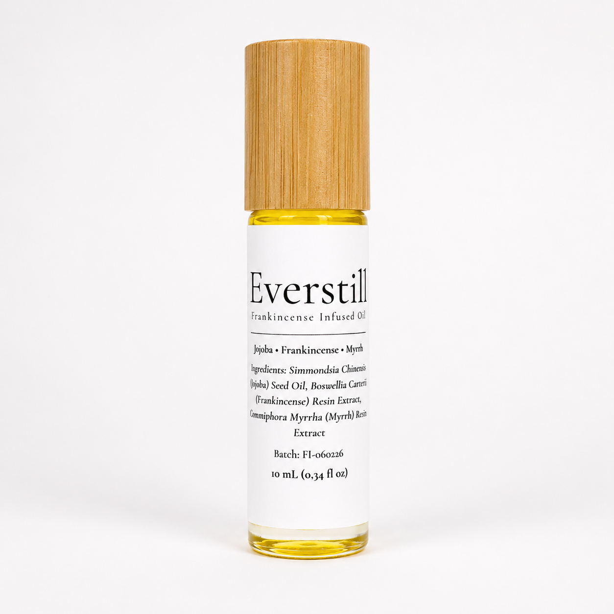 Everstill Frankincense & Myrrh infused oil roller bottle with bamboo cap on a soft neutral background.