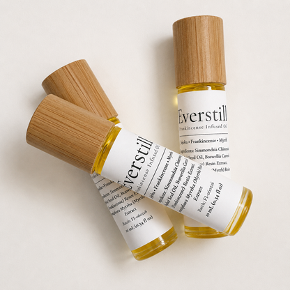 Two Everstill Frankincense & Myrrh infused oil roller bottles with bamboo caps displayed on a clean white background.